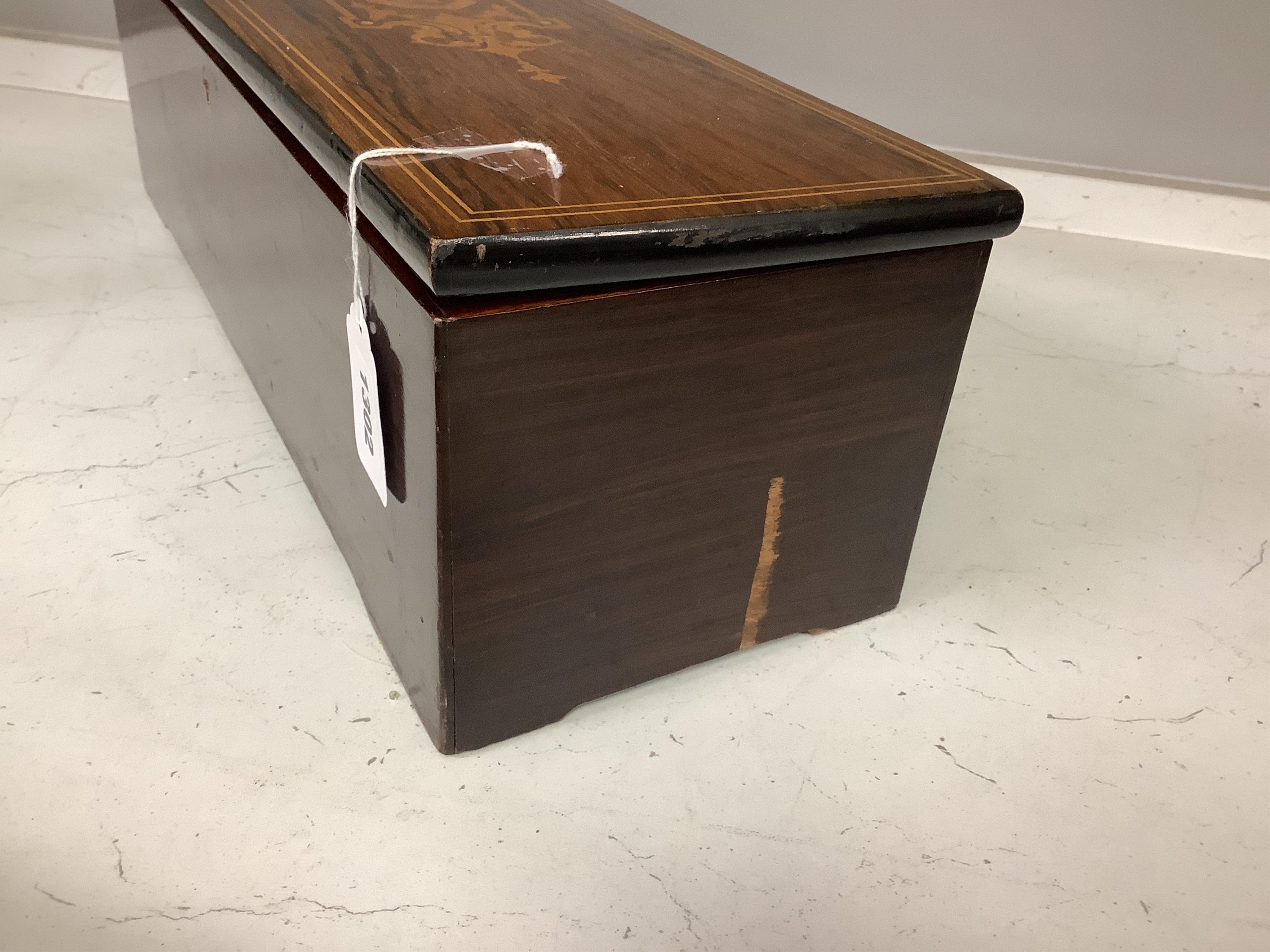 A 19th century Swiss rosewood and marquetry cased cylinder music box, signed Nicole a Geneve, with engraved serial number 11039, the cylinder is 32.5cm long, the case; 51cm wide, 15cm high, 17cm deep